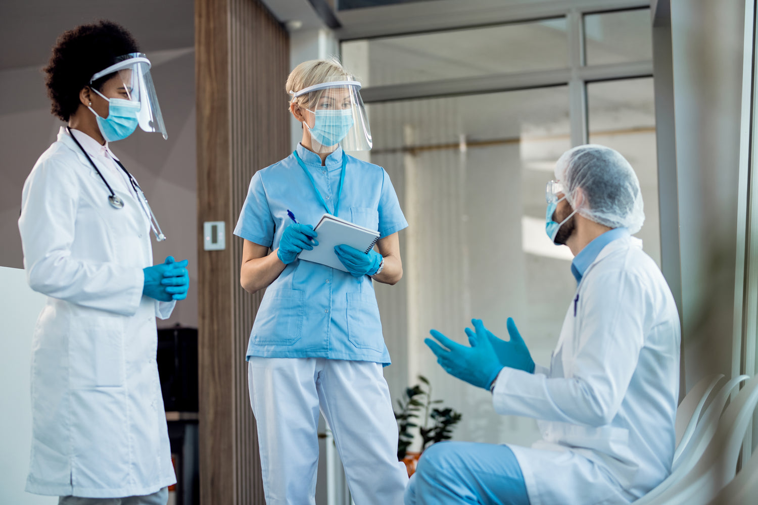 Healthcare worker wearing blue nitrile gloves while providing patient care