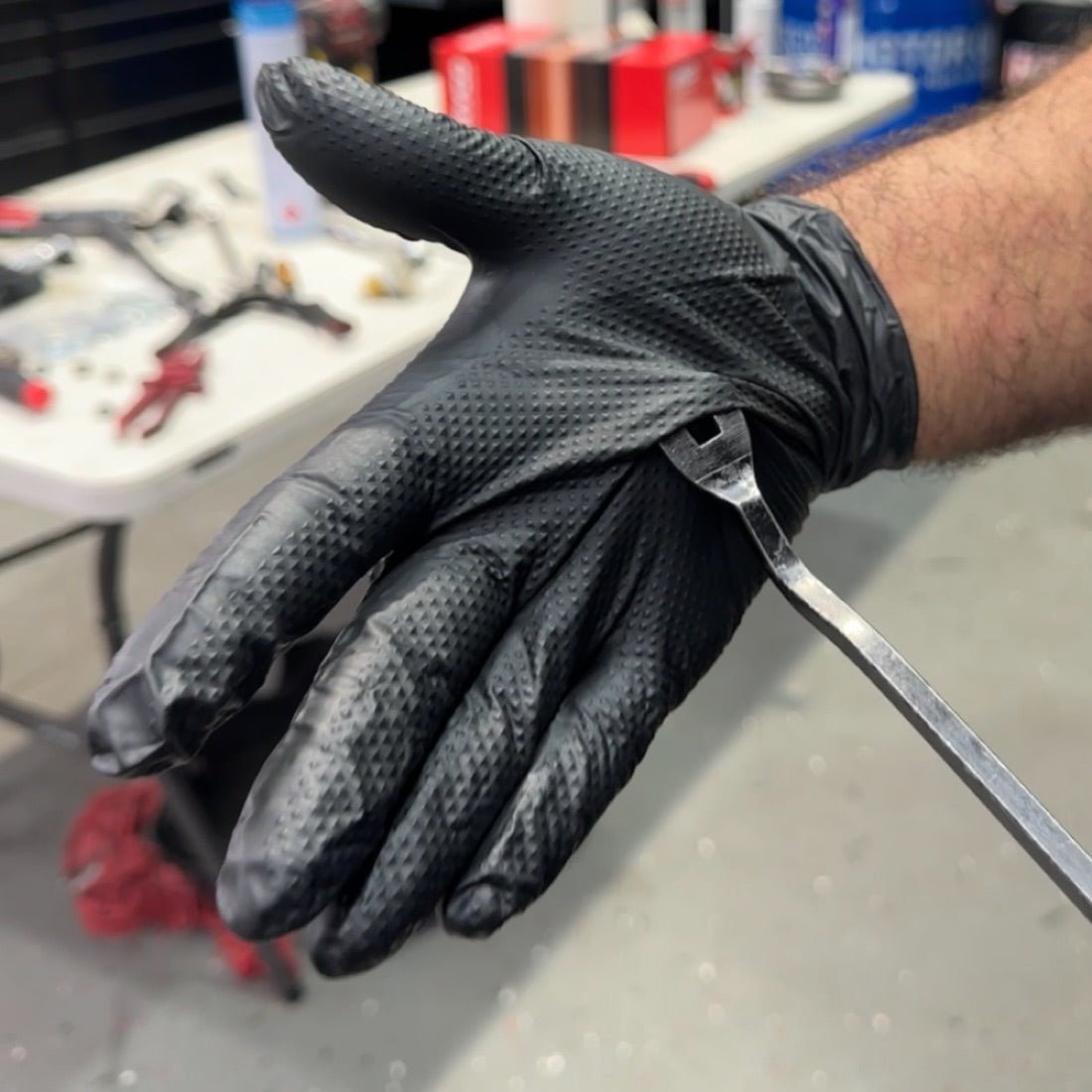 Aussie tradie gripping a tool in a Grip-X diamond-textured glove